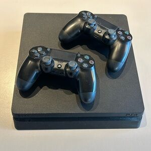 PlayStation 4 PS4 slim game console with two controllers